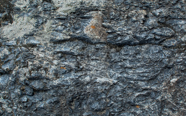 The texture of the stone. Dark background. Natural relief pattern