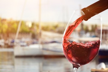 Red wine and glass on background