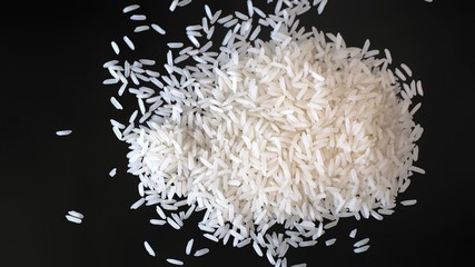 Pile of white polished Jasmine rice on black background