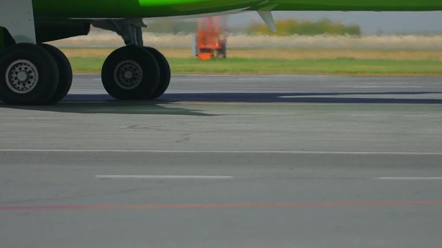 airplane aircraft moving and taxiing along runway at international airport. Jet turbine and chassis close-up, engine of aircraft. Jet airliner plane moving driving. takeoff landing traveling. close up