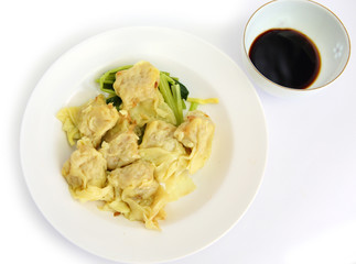 Dumplings on white plate with sweet sauce