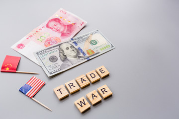 Creative top view flat lay of China and USA flags and cash money, mockup and copy space on gray background in minimal style. Concept of trade war between USA and China