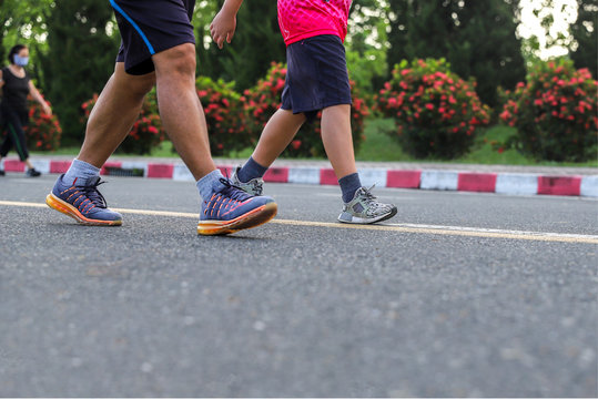  legs of couple man exercise with walking at the park.