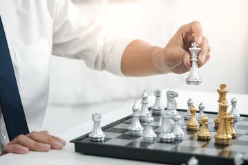 Businessman play with chess game. success management concept of business strategy and tactic...