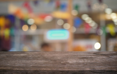 Empty dark wooden table in front of abstract blurred bokeh background of restaurant . can be used for display or montage your products.Mock up for space.