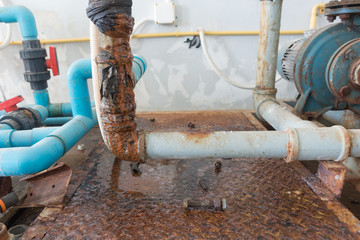 Water leaking from old rusty water supply pipe in water treatment plant