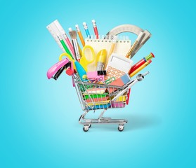 Colorful school supplies in shopping cart