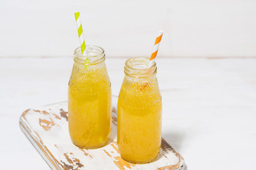 bottles of homemade citrus lemonade on a white background, top view