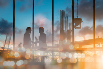 abstract bokeh background glitter and vintage lights background over Silhouette of engineer and construction team working at site. The party celebrating the success of important projects