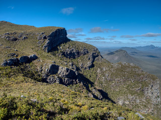 Scenic view of green Rocky Mountains range and blue sky