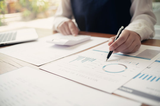 Accountant working with data documents calculating on business report.
