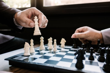 business man leadership playing chess board together, risk and strategy, investment concept.