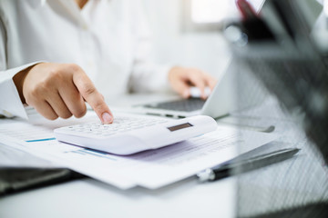 Accountant working with data documents calculating on business report.