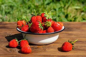Fresh ripe strawberry on a wooden table outdoor