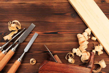 chisels plane and sawdust on a wooden table.