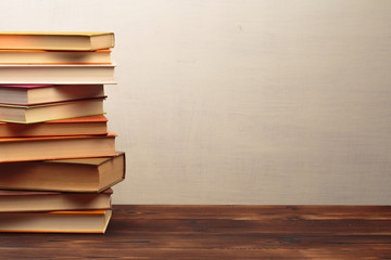 Stack of books on a wooden dest .Education.