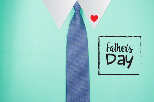 Happy Father's Day text with tie on green paper background