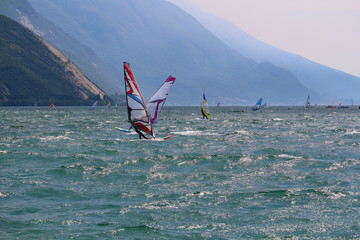 Windsurfers at Lake Garda glistening in the sun (Torbole, Italy)