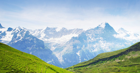 Fototapeta na wymiar Alpine peaks of Grindelwald and Jungfrau. Landskape background of Bernese highland. Alps, tourism, journey, hiking concept.