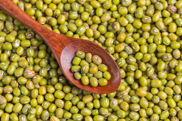 Green beans in woodspoon on green beans background