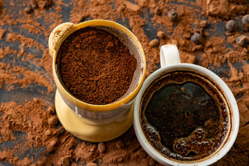 op view of the electric coffee bean grinder on the table, coffee powders
