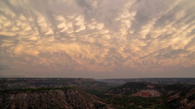 Sunset time lapse over Palo Duro Canyon in Texas viewing mammatus clouds as they change color in the sky.