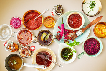 Overhead view of bowls and plates containing sauce