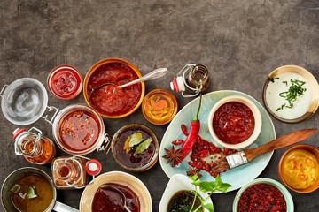 Bowls of sauces partially covering background - obrazy, fototapety, plakaty