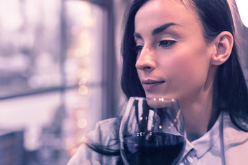 Pleasant thoughtful woman looking into the window