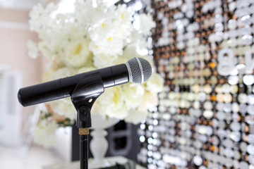 Microphone on the stand. Place to speak at the event. Holiday concept.