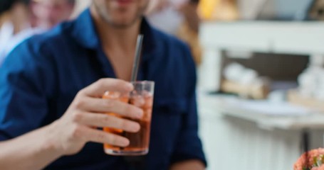 Man drinking cocktail at happy hour aperitif in city cafe.Medium portrait shot Friends italian trip in Umbria.4k slow motion - Powered by Adobe