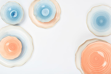 Set of colored ceramic plates on white background