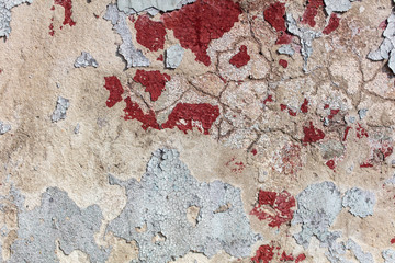 Concrete wall with cracked paint as abstract background