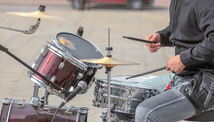 Man playing drums at a concert in the park
