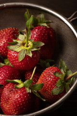 strawberries: closeup on dark background