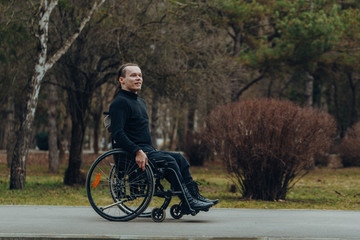 Portrait of a happy man on a wheelchair in a park