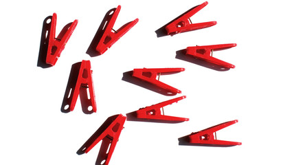 background chaos on white background of red clothespins