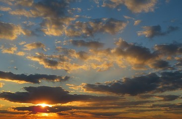 Beautiful fiery orange sunset in the sky, natural cloudscape