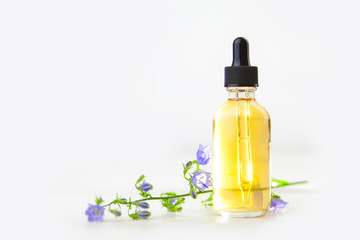Obraz na płótnie Canvas bellflower essential oil in beautiful bottle on White background