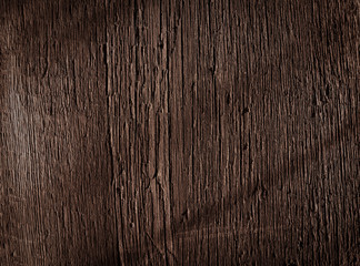Texture of dark brown old rough wood. Abstract background for design. Vintage retro