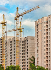Fototapeta na wymiar Construction site with cranes, urban background