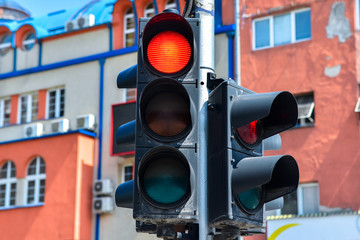 Red traffic light close up on a urban cityscape