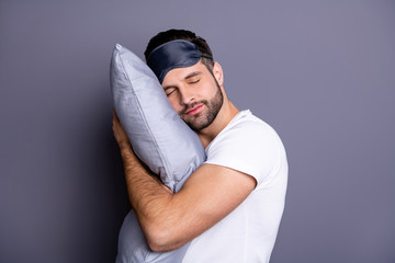 Close-up portrait of his he nice attractive bearded guy holding in hands pillow drowsiness going to...