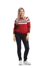 Yung blond female wearing a christmas red sweater and posing