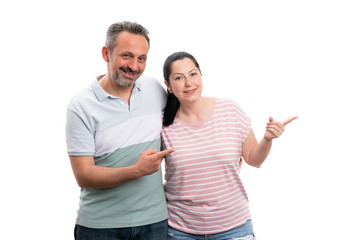 Fototapeta premium Couple pointing at copyspace