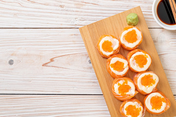 Obraz na płótnie Canvas fresh salmon sushi roll with mayonnaise and shrimp egg