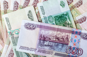 Money. Russian rubles. Notes in denominations of five, ten, one hundred and five hundred rubles. Cash. Background texture. Rub.