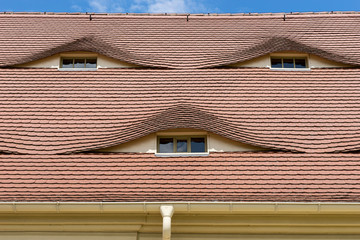 Semi-circular windows in the roof in a country cottage