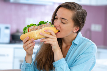 Hungry woman eat homemade sandwich. Food addiction and enjoying food. Gluttony and overweight...