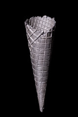 Empty black ice cream cone isolated on black background